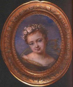 A Child In White Lace-trimmed Smock, A Green Shawl Around Her Shoulders With Yellow And Orange Striped Trim