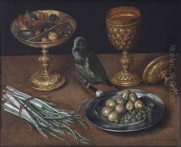 A Golden Tazza With Dates And Dried Fruits, A Golden Goblet And Cover, A Tin Plate With Olives And Capers And A Green Finch Seated On A Fork, Together With Asparagus On A Wooden Table - view 1