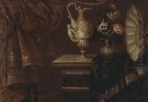 A Still Life With An Ewer, Footed Basin And Flowers In A Glass Vase On A Partially Draped Table by Antonio Gianlisi