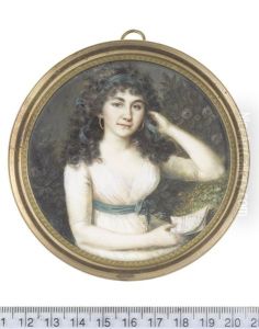A Lady, Seated In A Garden, Wearing White Dress, Dark Green Sash With Silver Tassels And Tied In A Ribbon Bow At Her Side, Gold Hooped Earrings