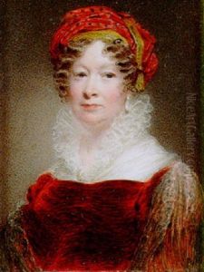 A Lady Seated In An Upholstered Chair Wearing Burgundy Colored Dress