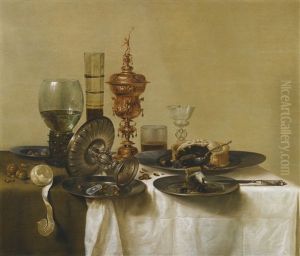 A Still Life With A Gilt Cup, A Silver Tazza, Glasses And Pewter Plates With A Pie, Peeled Lemon And Nuts, All Upon A Draped Table by Willem Claesz Heda