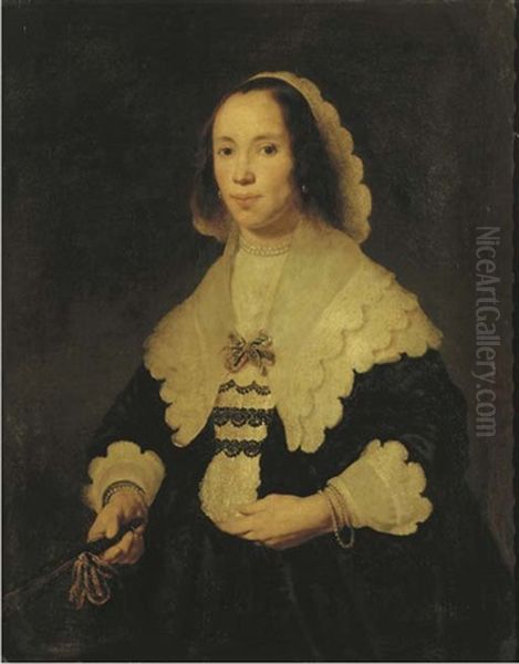 Portrait Of A Lady In A Black Dress, With Lace Cuffs And Collar, Holding A Fan In Her Left Hand by Bartholomeus Van Der Helst