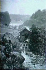 Berglandskap Med Kvarnbyggnad-i Fonden Smastad Vid Vatten by Ferdinand Hernlund