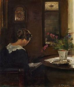 Interior With The Artist's Wife Reading At A Table by Carl Vilhelm Holsoe
