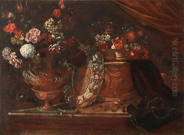 A Bronze Urn Filled With Flowers Alongside A Silver Dish - view 1