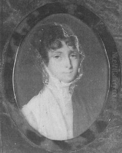 A Lady, In White Dress, Brown Shawl Over Her Left Shoulder And Lace Veil Over Her Brown, Curled Hair