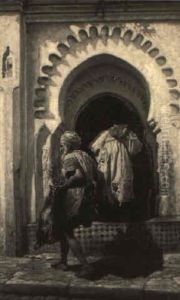 Water Vendor Passing By The Entrance To A Mosque