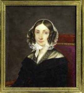 Portrait D'une Jeune Femme En Robe De Dentelle Noire Assise Dans Un Fauteuil De Velours Rouge; Coiffee D'anglaises, Elle Porte Un Bonnet De Dentelle Blanche