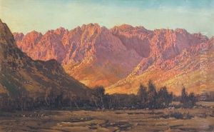 View Of Sunlit Mountains Across A River