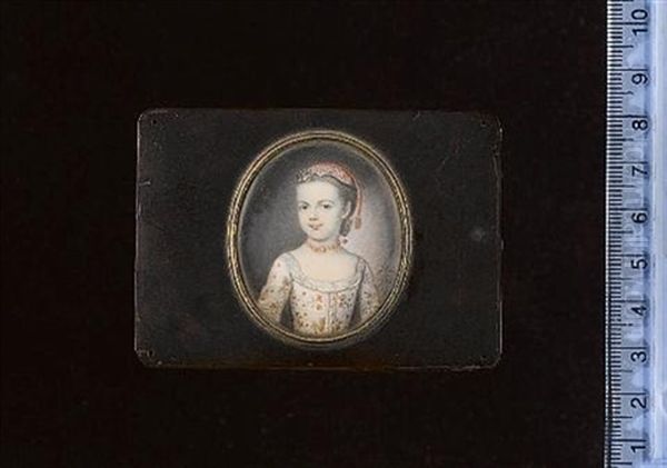 A Young Girl Wearing White Dress With Elaborate Floral Decoration, Lace Trim And Buttons, Coral Tasselled Cap And Matching Necklace, Flowers Adorn Her Hair - view 1