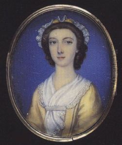 A Young Lady Wearing Pale Yellow Dress, White Scarf With Ribbon At Her Corsage And White Lace Cap With Yellow Ribbon In Her Curled Hair