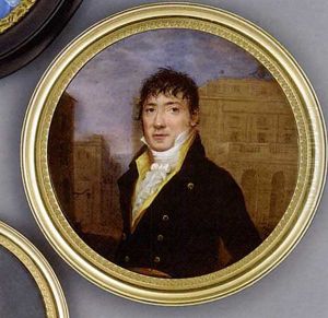 A Gentleman Standing In A Street With Buildings Beyond, In Black Coat With Gold Buttons, Yellow Waistcoat And Frilled Cravat, Forward Combed Dark Hair
