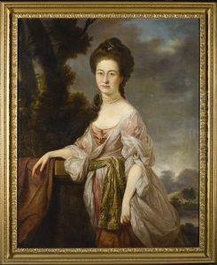 Portrait Of A Lady, Three-quarter-length, Standing In A Landscape, Wearing A Pink Dress With White Lace Sleeves And An Embroidered Waistband