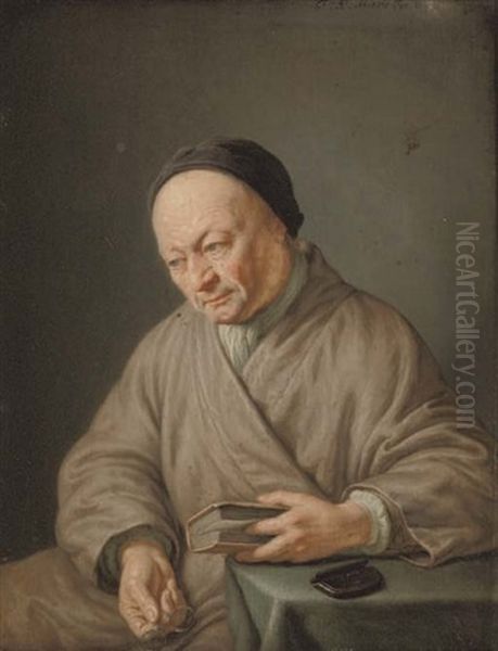 An Elderly Man Seated In A Beige Robe With A Black Cap, Holding A Book In His Left Hand And Glasses In His Right - view 1