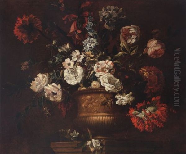 Roses, Delphiniums, Carnations, Peonies, Narcissi And Other Flowers In A Sculpted Urn On A Stone Ledge - view 1