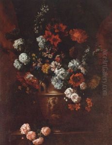 A Still Life Of Roses, Parrot Tulips, Lilac, Marigolds, Cornflowers And Other Flowers In A Sculpted Vase On A Stone Plinth Within A Niche