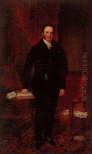 Portrait Of Stuart Majoribanks In A Black Suit, Resting His Right Hand On A Writing Table
