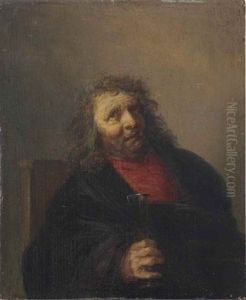 A Bearded Man Seated In A Chair Drinking