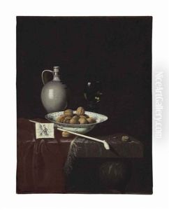 Walnuts In A Wan-li Porcelain Bowl, A Stoneware Jug, A Pipe, A Packet Of Tobacco, And A Roemer Filled With Wine On A Partially Draped Marble Table by Hubert van Ravesteyn