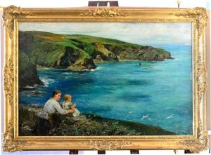Mother And Child Seated On Headland Looking Out To Sea