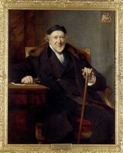 Portrait Of Sir Moses Montefiore Seated At A Desk, In A Black Suit And Cap