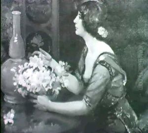Young Woman Seated At A Table Young Woman Seated At A Table