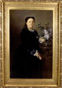 Femme Dans Un Interieur Pres D'un Vase De Lilas by Lionel Noel Royer