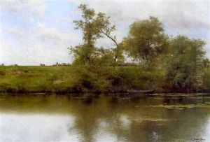 A Tranquil River Landscape With Waterlilies In The Foreground