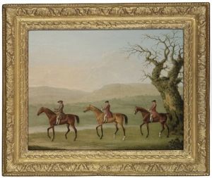 A Trainer And Two Grooms Exercising Racehorses
