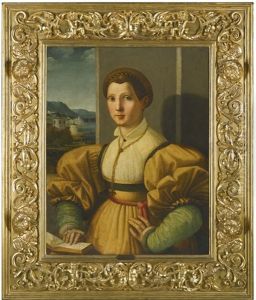 Portrait Of A Lady, Half-length, In A Yellow Dress With Green Sleeves And A Gold Chain, Resting Her Hand On A Book In An Interior, A River Landscape Beyond