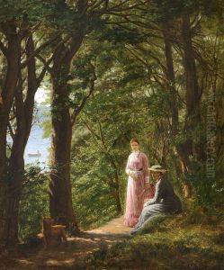 Two women and a dog on a path in the woods with a view of the sea on a summer day.