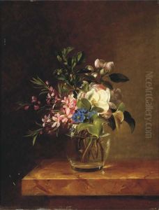 Springblossom in a glass on a marble ledge.