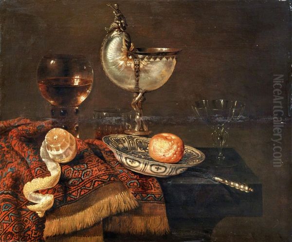 A clementine in a porcelain bowl, a nautilus cup, a roemer, two glasses, a knife, a peeled lemon on an ornamental carpet on a table - view 1