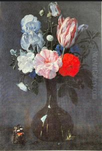 Roses, a tulip and an iris in a glass vase on a stone ledge