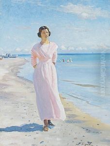 Ung kvinde i lyserod kjole pa Skagen Sonderstrand.