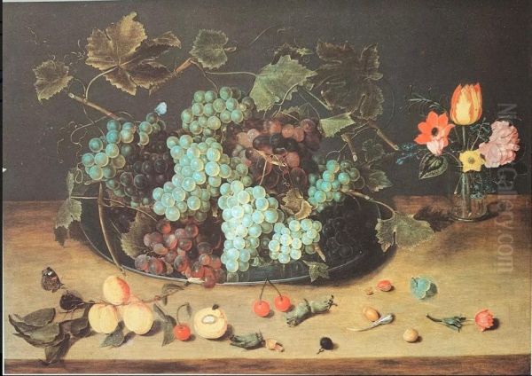Glass of flowers and plate with grapes - view 1