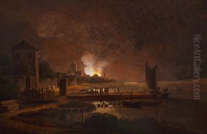 A fire in a town at an inlet.