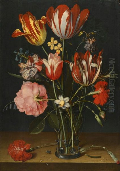 Still life of tulips, carnations, a rose and other flowers in a glass beaker resting on a wooded ledge - view 1