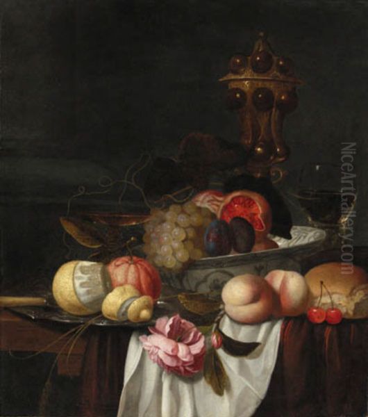 Grapes, pomegranates and plums in a Wanli bowl, an orange and peeled lemon on a pewter plate, peaches, cherries, bread, a rose, a roemer, a silver-gilt cup and tazza - view 1