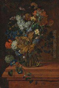 Flowers in a glass vase on a marble ledge