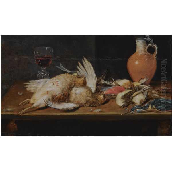 A still life with a robin, a kingfisher, partridges and songbirds, all on a wooden table, together with a glass and an earthenware jug - view 1