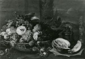A fruit still life with a Wanli bowl with fruit and a wine glass on a table, a landscape beyond by Frans Snyders