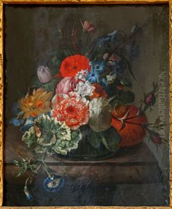 Flowers in a glass vase on a marble ledge