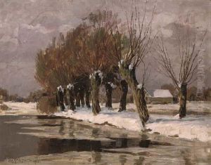 An Avenue Of Trees By A Lake In A Snowing Landscape