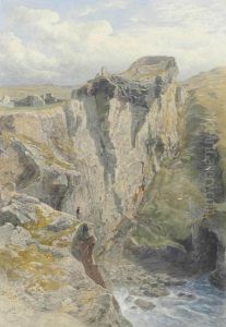 A Figure On The Cliff Overlooking The Sea Below The Ruins Of Tintagel Castle, Cornwall