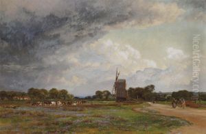 Cattle Grazing Before A Windmill