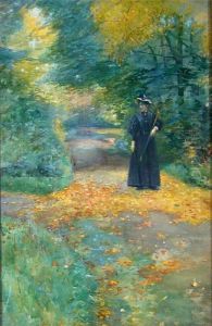 Spaziergangerin Auf Herbstlichem Parkweg by Rudolf Possin