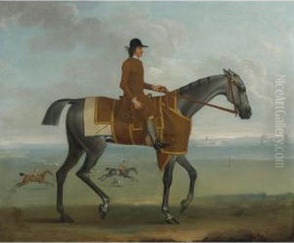 A Grey Racehorse With A Jockey Up Exercising On Newmarket Heath - view 1